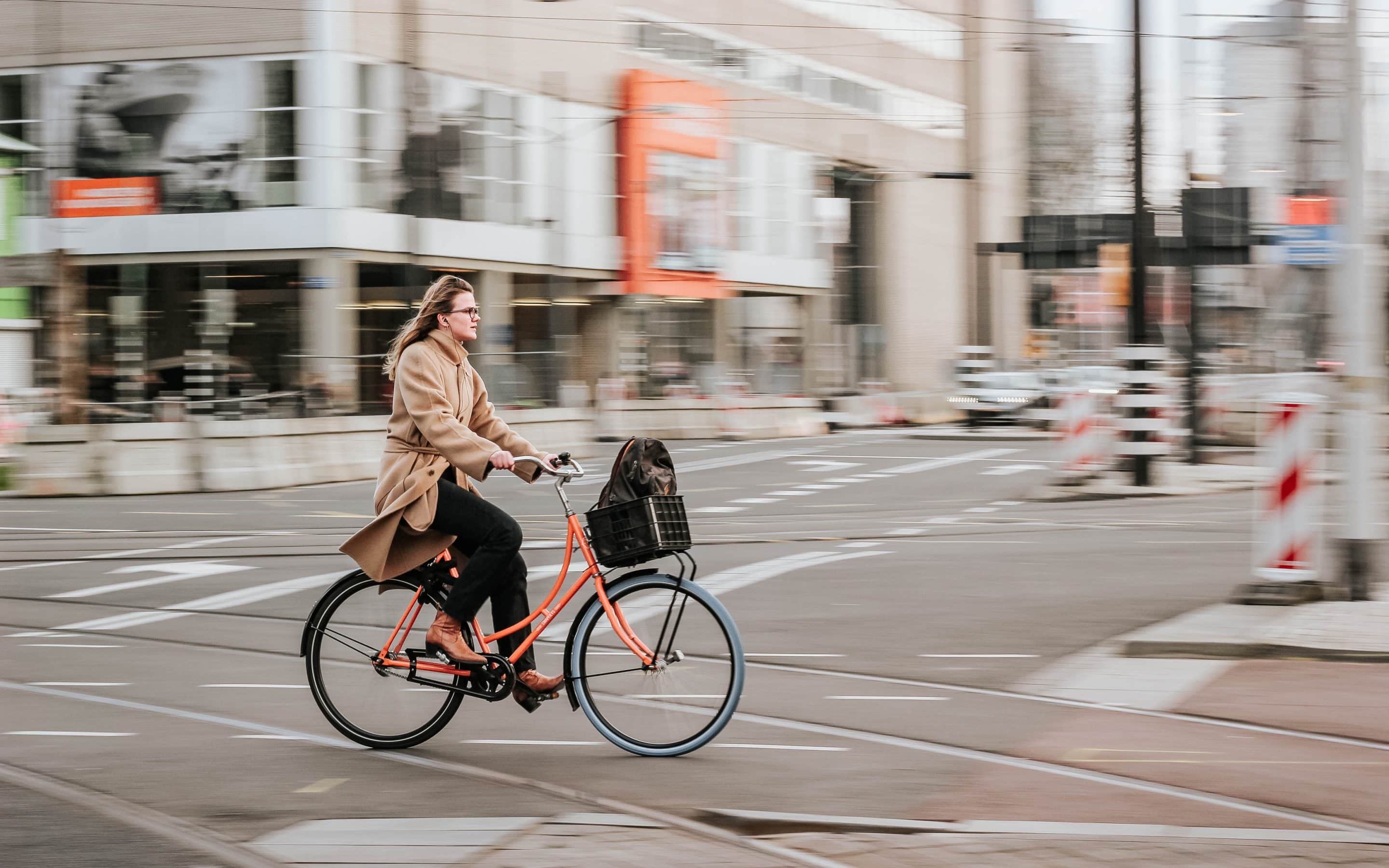 woman cycling on city streets