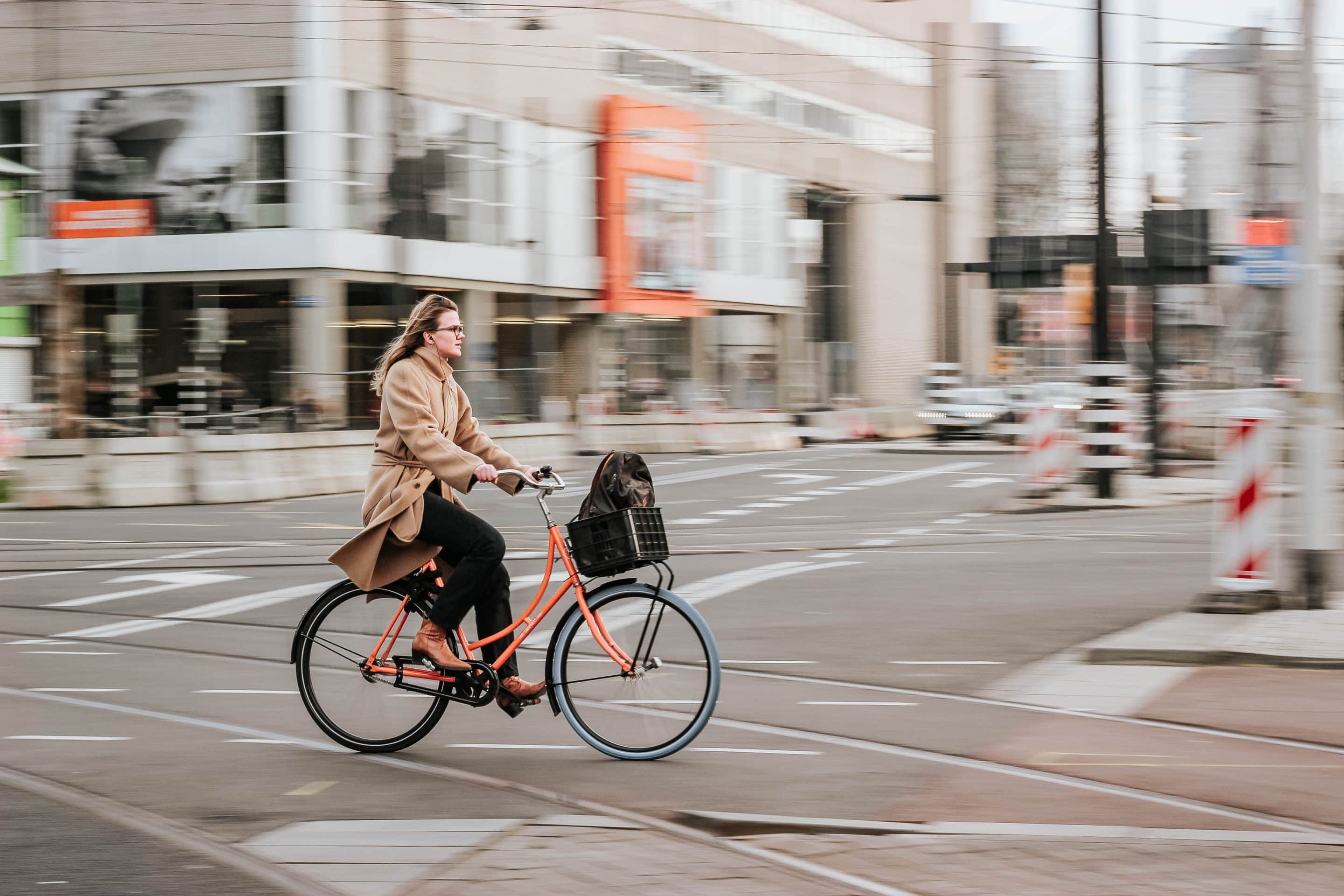 woman cycling on city streets